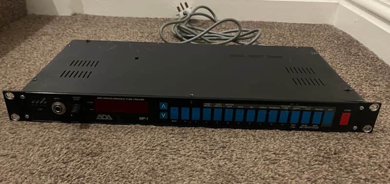 Black audio preamplifier with digital display and input/output controls.