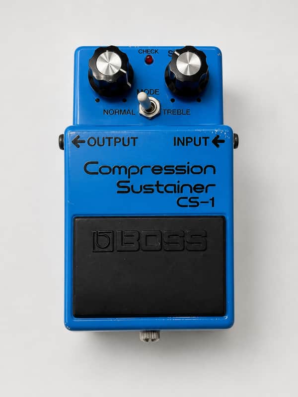 Assortment of Boss guitar effects pedals and packaging, various colors.