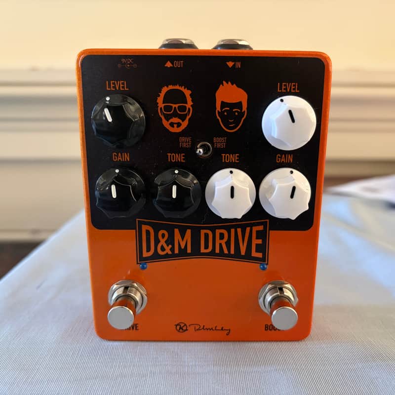 Orange D&M Drive guitar pedal with black knobs and orange casing.