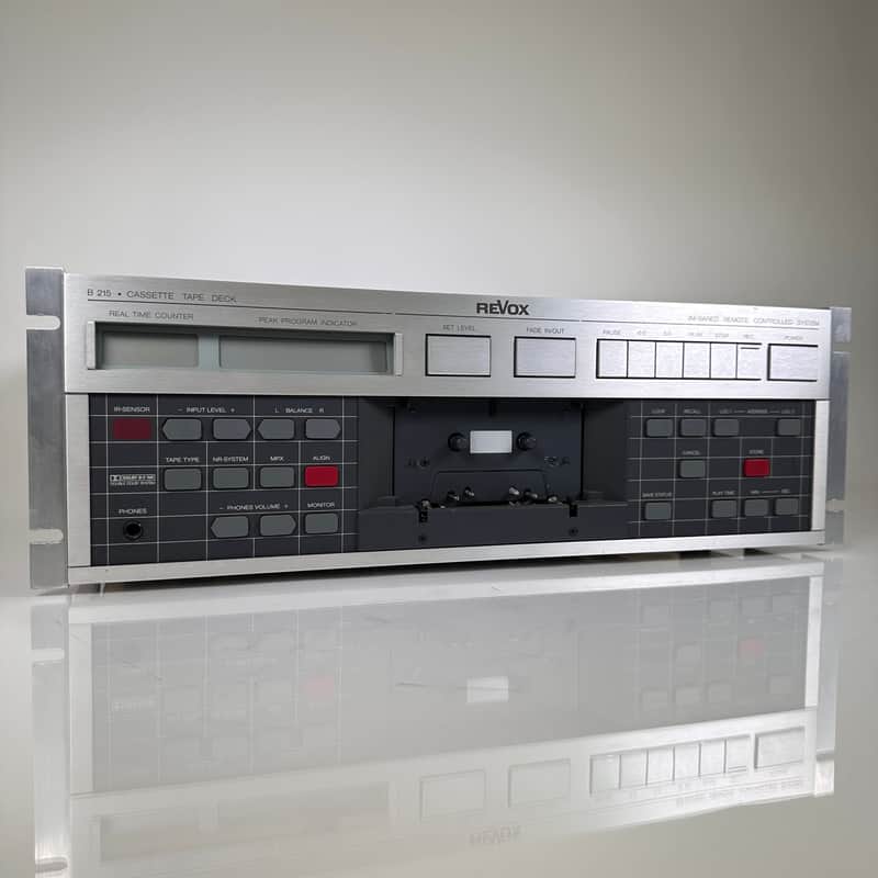 Silver Revox cassette tape deck with various controls and meters visible.