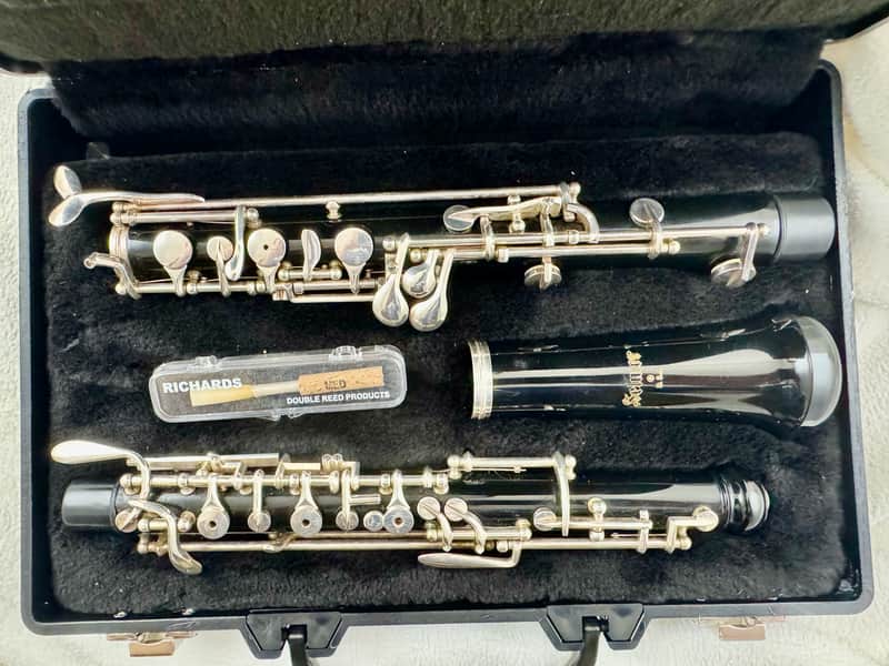 Silver and black brass instruments in blue velvet case.