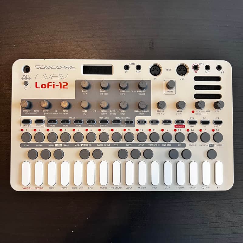 Red and white analog mixing console inside open black carrying case.