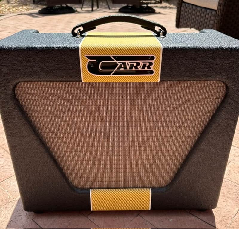 Grey and orange vintage-style guitar amp head with brown grille cloth.