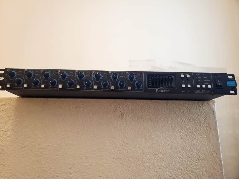 Row of black Focusrite audio interfaces on a brown cardboard box.
