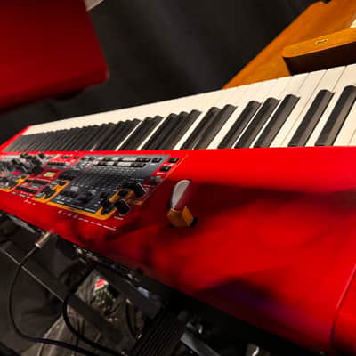 Nord Stage 2 Ex 88 2015-2017 - signature red painted chassis paired with distinct, exposed wooden side panels (cheeks) that give it a premium, classic-meets-modern aesthetic. image 4