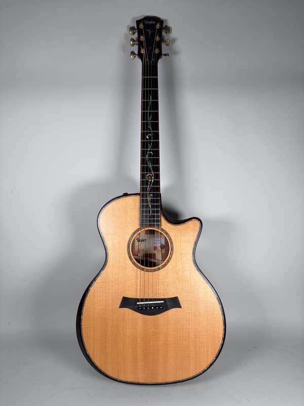A vintage-style acoustic guitar with a sunburst finish rests on purple steps.