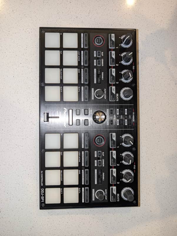 Black Pioneer DJ controller with white grid pads, loose in packaging.