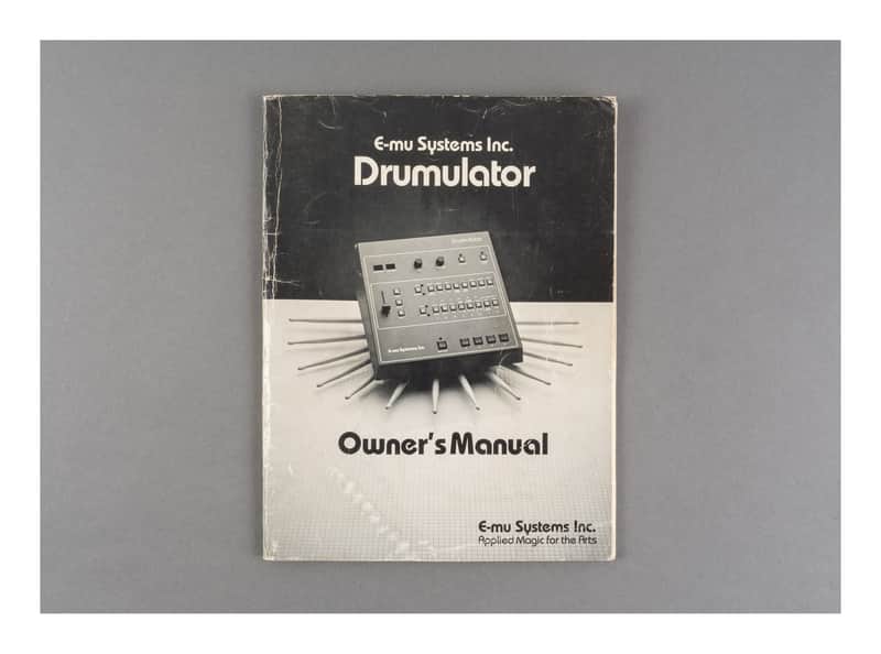 Black and white E-mu Systems Drumulator owner's manual with small electronic unit pictured.