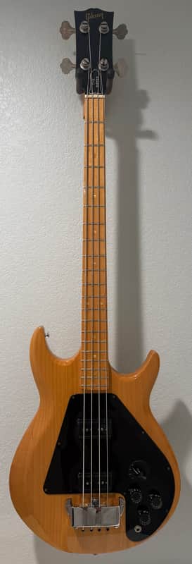 Black Gibson electric guitar with wooden body, visible neck and headstock.