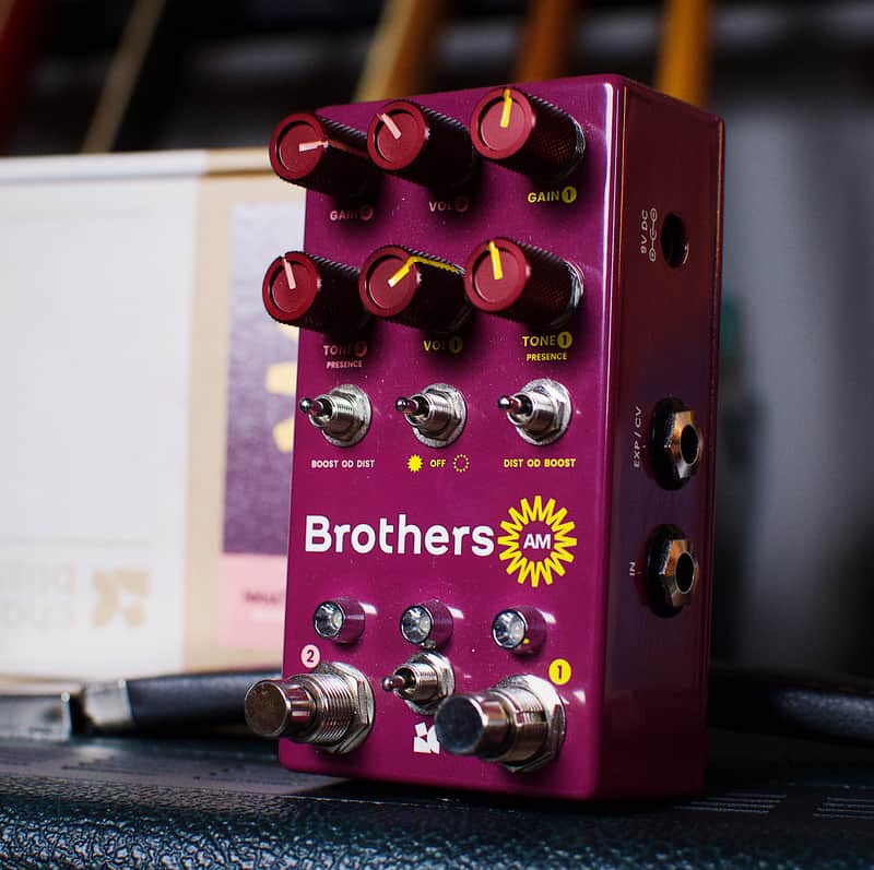 Purple guitar effects pedal with knobs and footswitches.