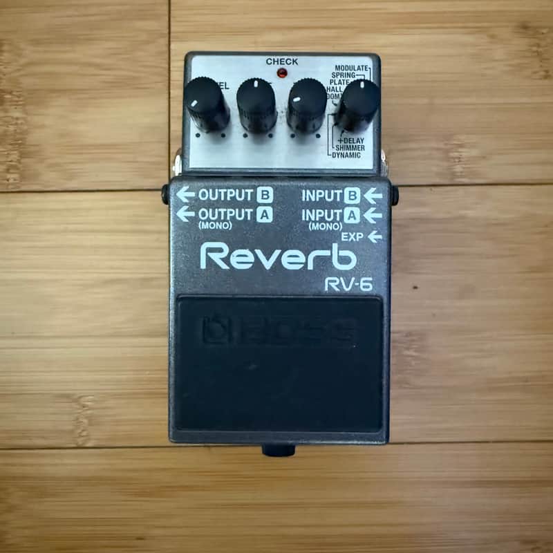 Reverb RV-6 pedal in open black case, showing knobs and jacks.