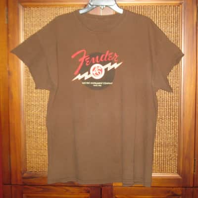 pre-owned genuine Fender Lightning Bolt Logo Short Sleeve, Cotton T-Shirt, XL, Brown (sleeves cut shorter) PN: 9101008621, from 2010, GRAPHIC: Red, Creme, Dark Brown, Fender, Ligntning Bolt, Circles, musical symbols, Electric Instrument Company Since 1946 image 1
