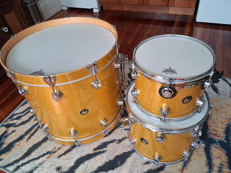 Blue and gold striped drum, polished hardware, visible drum head.