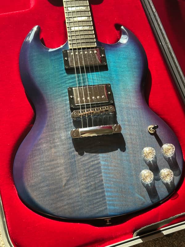 Purple electric guitar with black hardware, displayed on a clear stand.