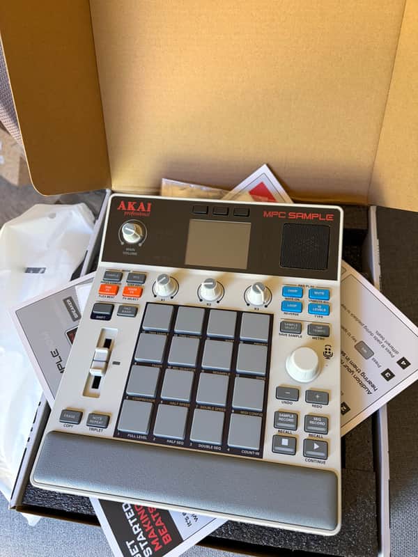 Akai MPC professional sampler with knobs, pads, and screen visible.