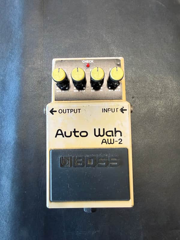 Gold and black BOSS Auto Wah AW-2 pedal with box visible.