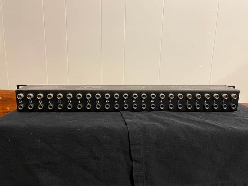Black and silver guitar pedal with 24 footswitches, showing wear on the top.