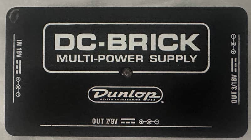 Black DC-Brick multi-power supply unit with Dunlop logo visible.