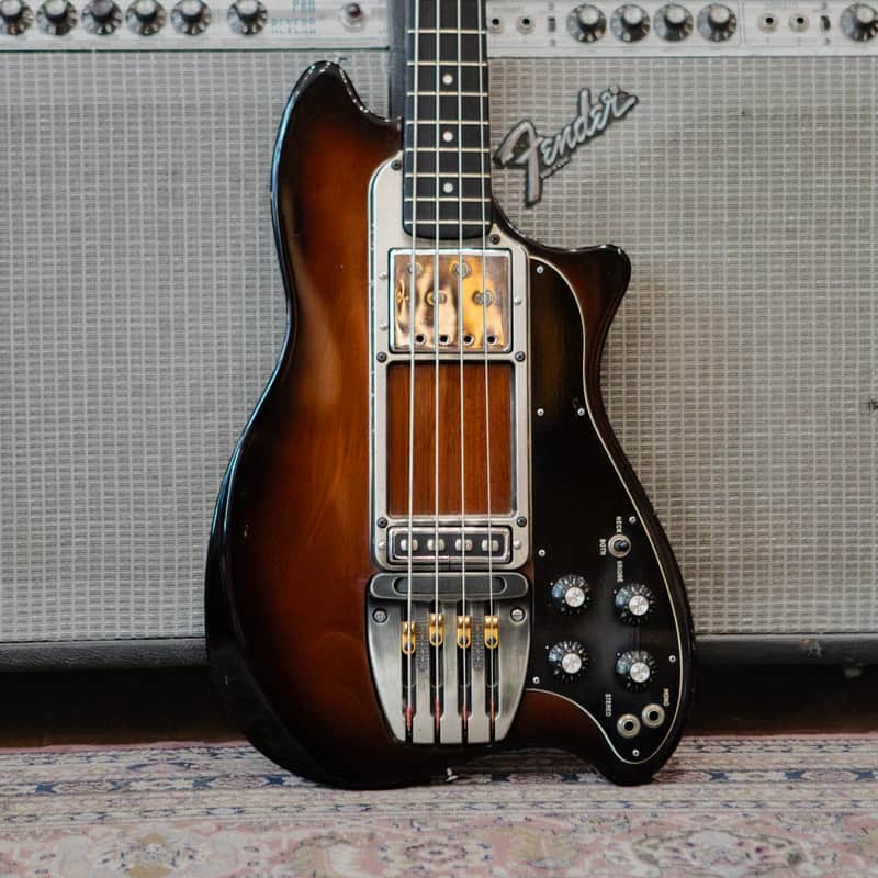 Brown electric guitar in open, velvet-lined hard case.