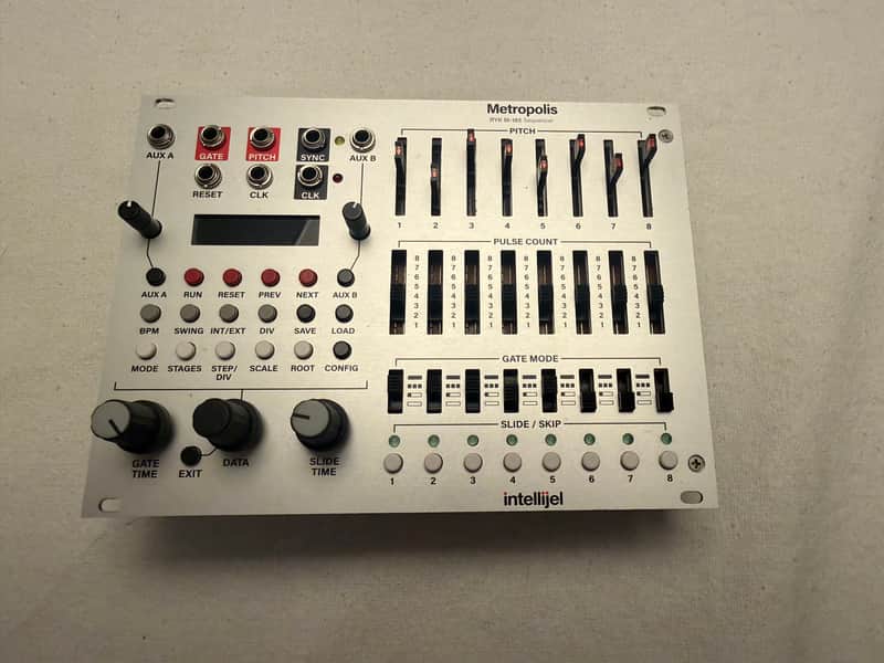 White electronic synthesizer with black knobs and buttons.