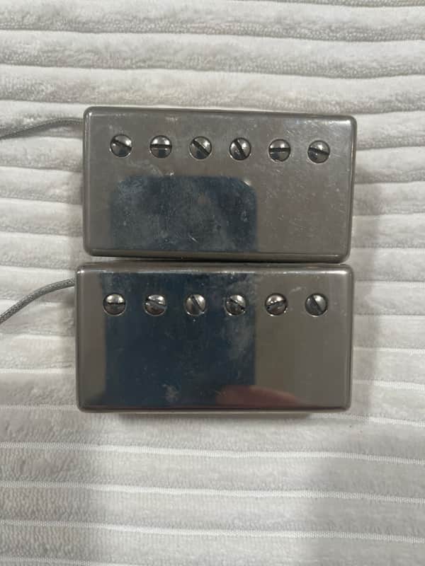 Two silver metal plates with visible mounting holes in a black case.