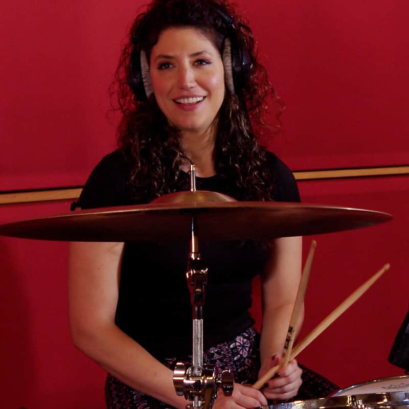 Jessica sitting at the drum set.