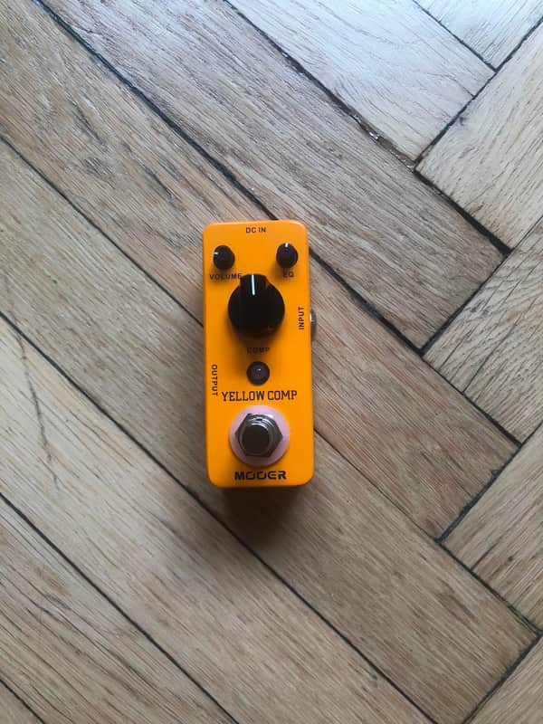 Yellow guitar effects pedal with knobs: Volume, EQ, Comp, and output.
