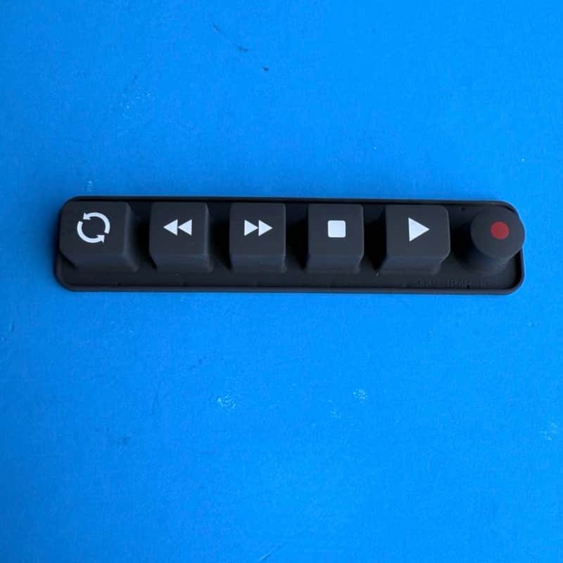 Black, rectangular, hinged plastic case shown against a bright blue background.