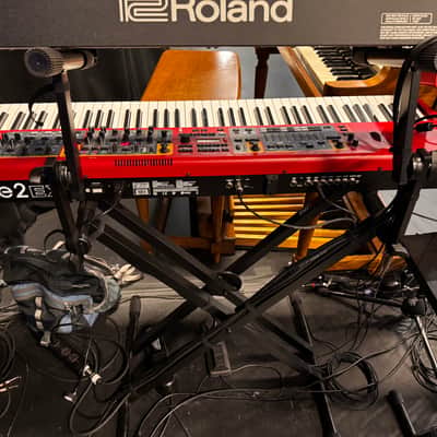 Nord Stage 2 Ex 88 2015-2017 - signature red painted chassis paired with distinct, exposed wooden side panels (cheeks) that give it a premium, classic-meets-modern aesthetic. image 7