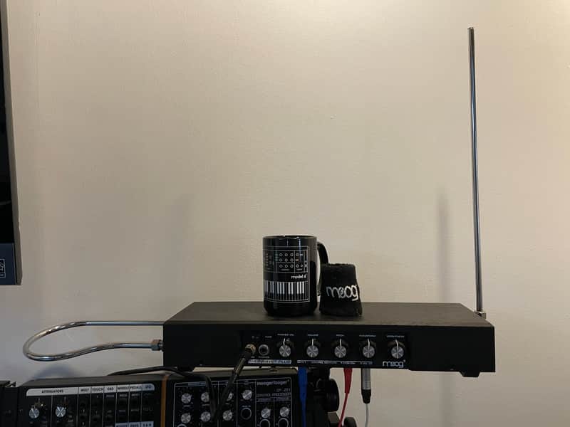 Wooden audio equipment, black cables, and a black microphone on a wooden surface.