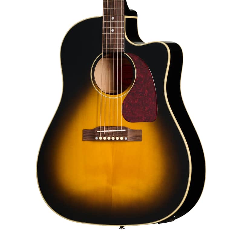 A sunburst acoustic guitar displayed on a wooden stand.