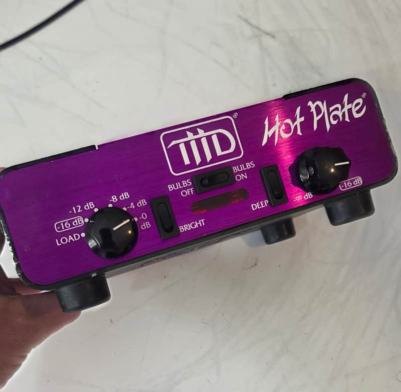 Purple and black Tidd Hot Plate amplifier with manual visible.