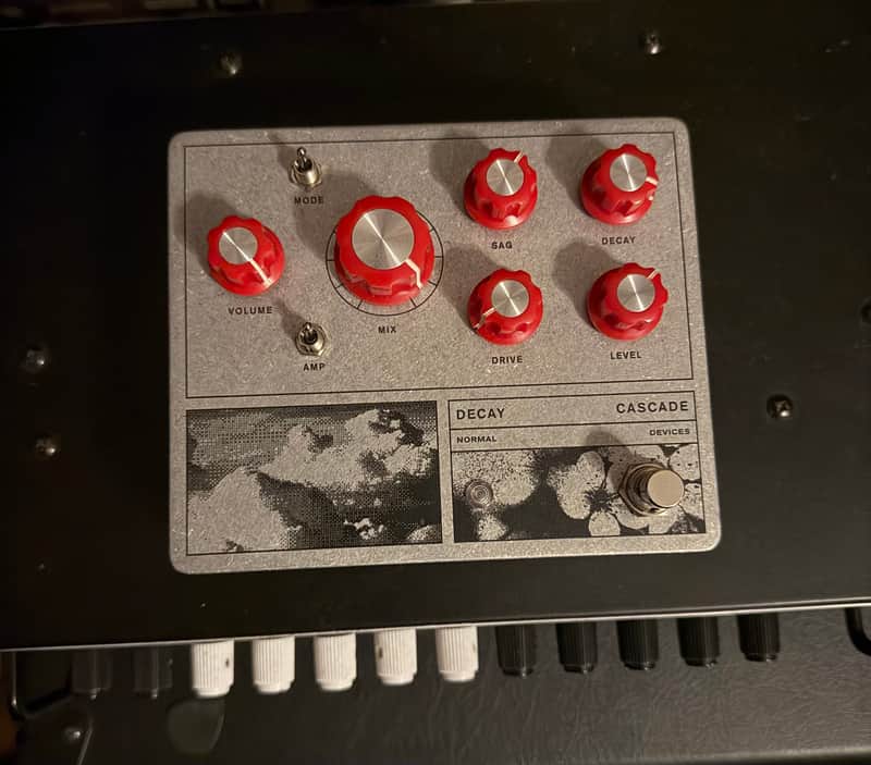 White guitar effects pedal with knobs and footswitch.