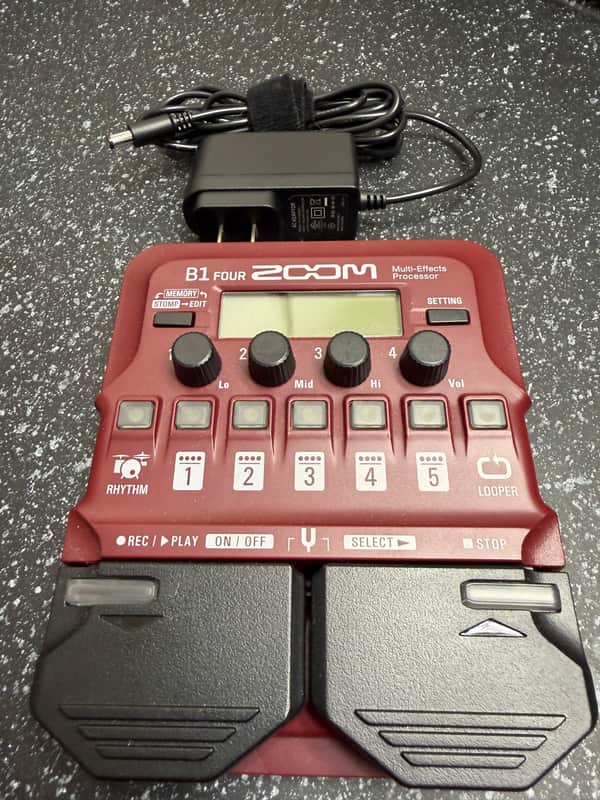 Red and black digital multi-effects processor with knobs and buttons.