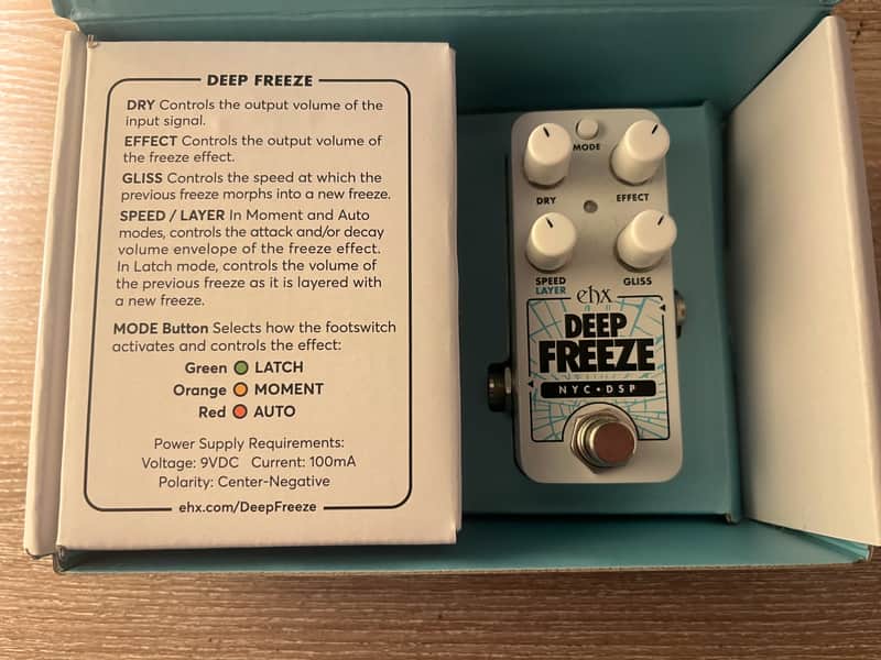 White guitar effects pedal with knobs and labeled switches.
