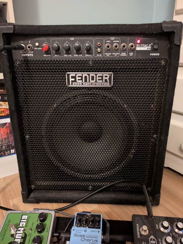 Black Fender guitar amplifier head and speaker cabinet, used condition.