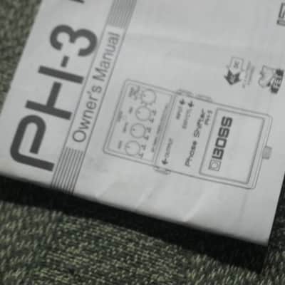 used (less than lite average wear) genuine Boss Owner's Manual for PH-3 Phase Shifter (NO: pedal / other items) 2000s (copyright year 2002) white matte paper / black print & graphic [5 inches across (unopened), 3 & 1/2 inches high] 32 pages cover to cover image 2