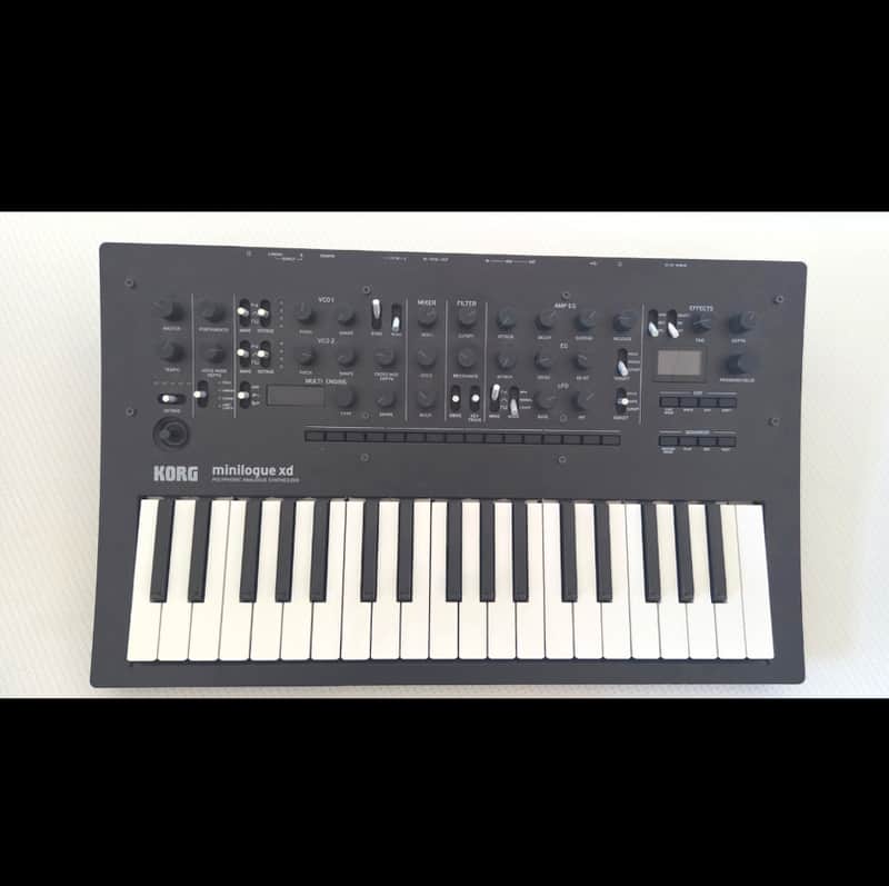 Black Korg minilogue xd synthesizer keyboard with white keys.