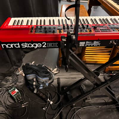 Nord Stage 2 Ex 88 2015-2017 - signature red painted chassis paired with distinct, exposed wooden side panels (cheeks) that give it a premium, classic-meets-modern aesthetic. image 9