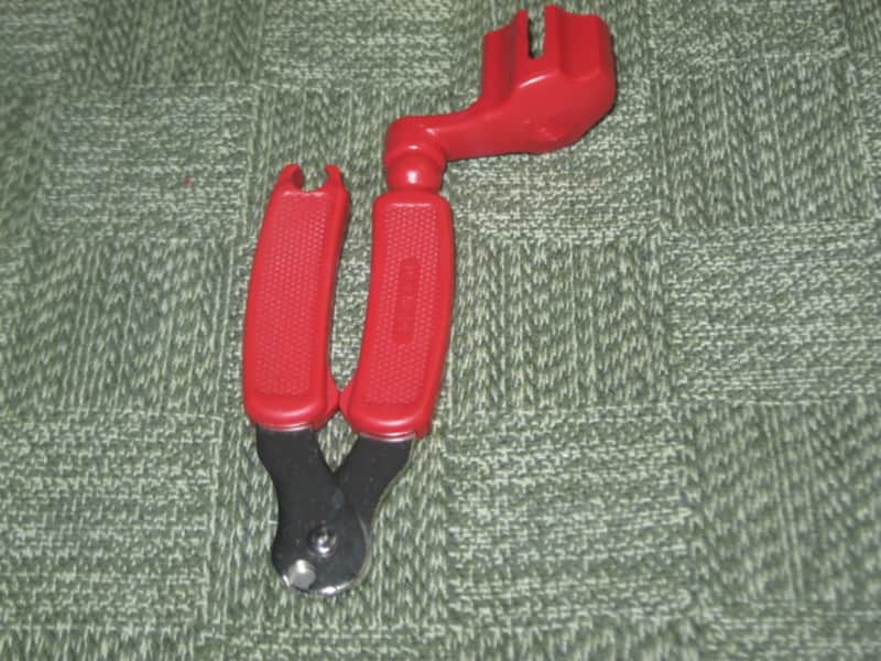 new old stock open package A+ D'Addario / Planet Waves 1st ver Pro-Winder RED String Winder & Cutter & Bridge PIn Puller, has different handle design than current DP0002 model,  from 2000s - for guitars, banjos, ukuleles, and mandolins image 1