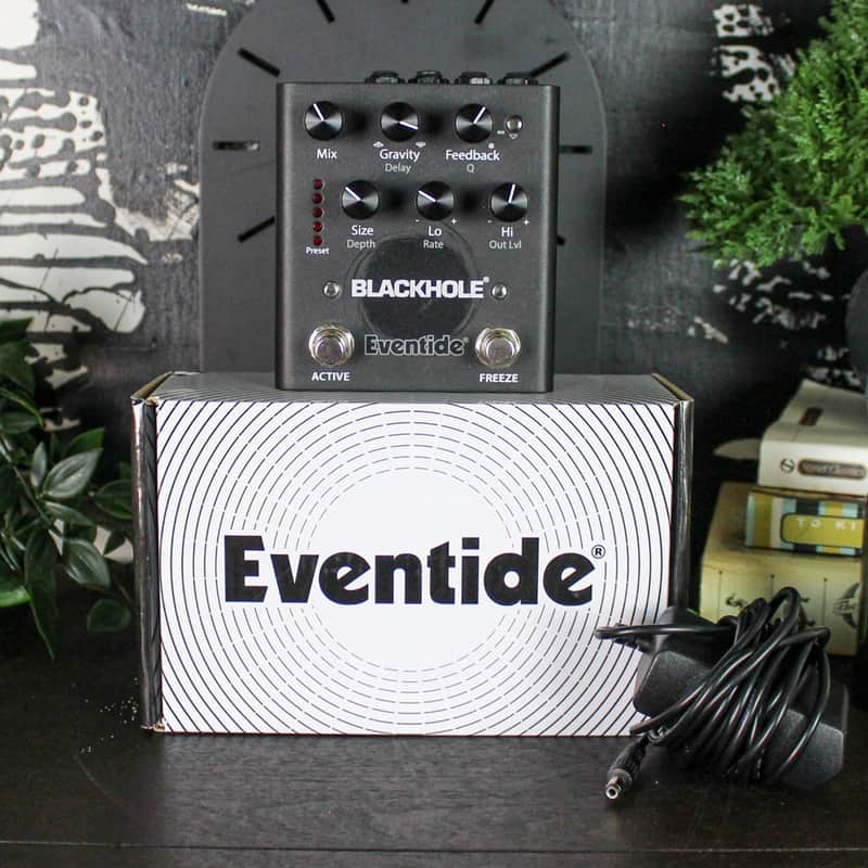 Orange electric guitar, Eventide box, Blackhole pedal, and amplifier visible.