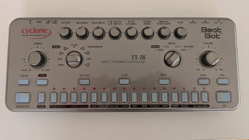 Silver and black electronic drum machine with various buttons and knobs.