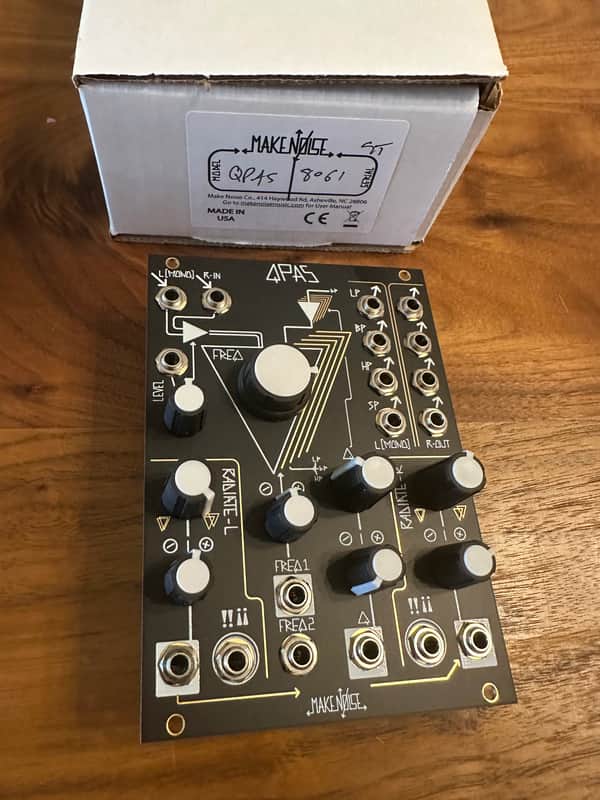 Black electronics circuit board with various jacks and knobs.