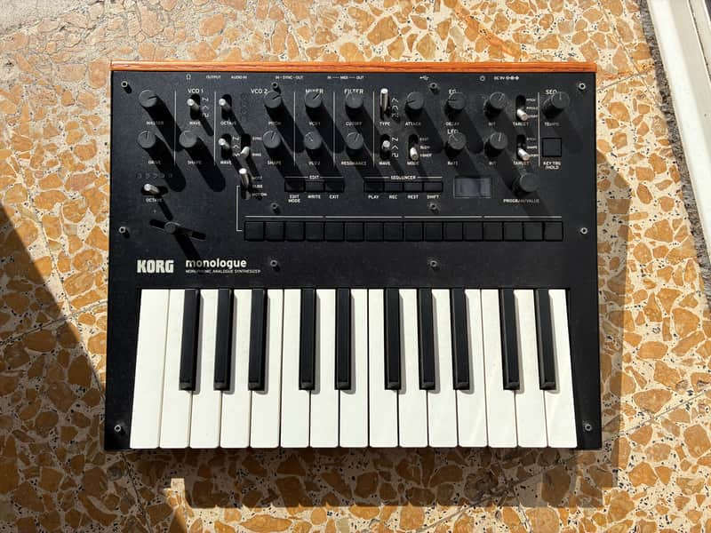 Black and silver Korg Monologue analog synthesizer keyboard in box.