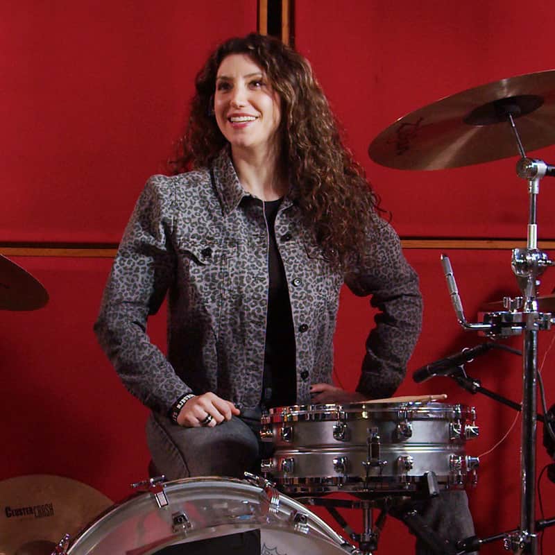 Jessica sitting at the drum set.