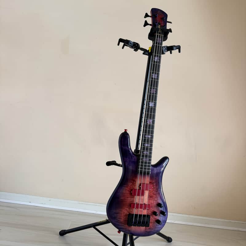 Red and white electric bass guitar, visible body and neck.