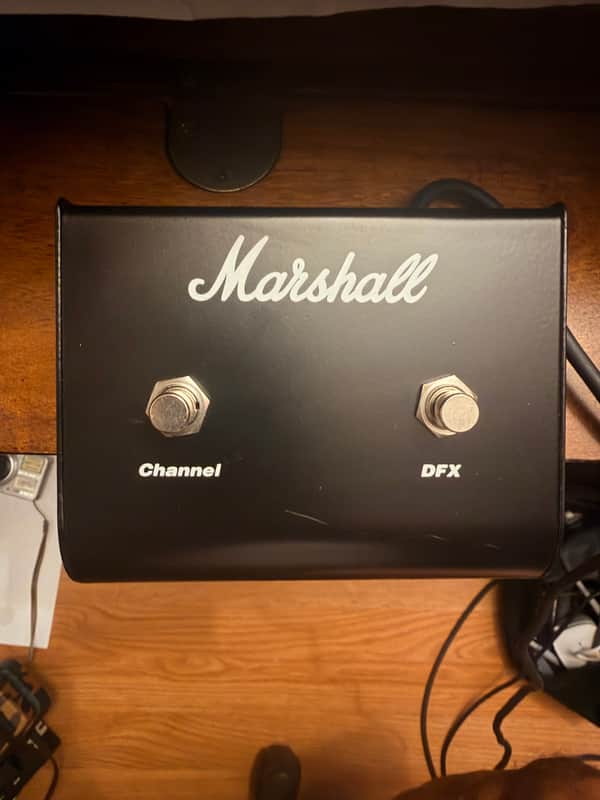 Black Marshall amplifier head with silver logo and two gold knobs.