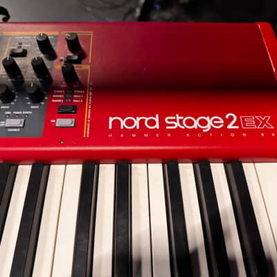 Nord Stage 2 Ex 88 2015-2017 - signature red painted chassis paired with distinct, exposed wooden side panels (cheeks) that give it a premium, classic-meets-modern aesthetic. image 6