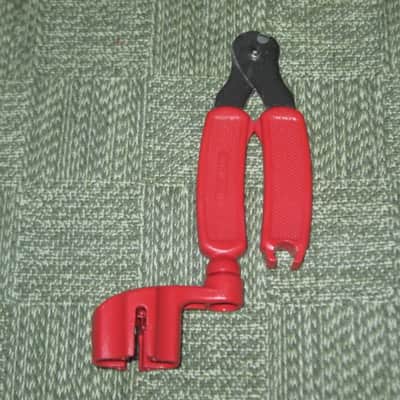 new old stock open package A+ D'Addario / Planet Waves 1st ver Pro-Winder RED String Winder & Cutter & Bridge PIn Puller, has different handle design than current DP0002 model,  from 2000s - for guitars, banjos, ukuleles, and mandolins image 5