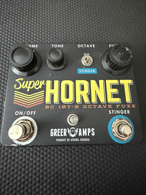 Black guitar effects pedal with knobs, labeled "Super Hornet.